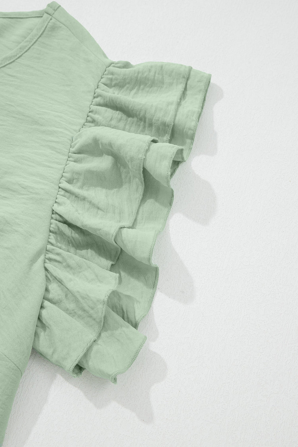 Somethinguluv plus size sage green blouse featuring layered flutter sleeves and a round neckline
