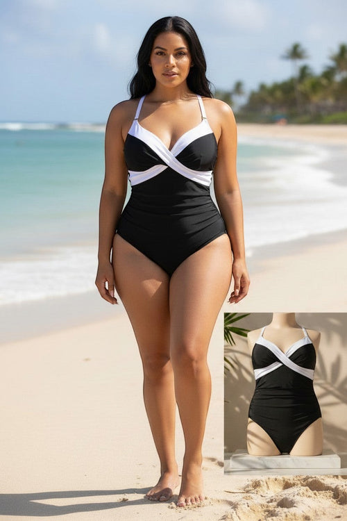 Somethinguluv3 black and white tuxedo slimming swimsuit with a flattering wrap-style bust on a model at the beach.