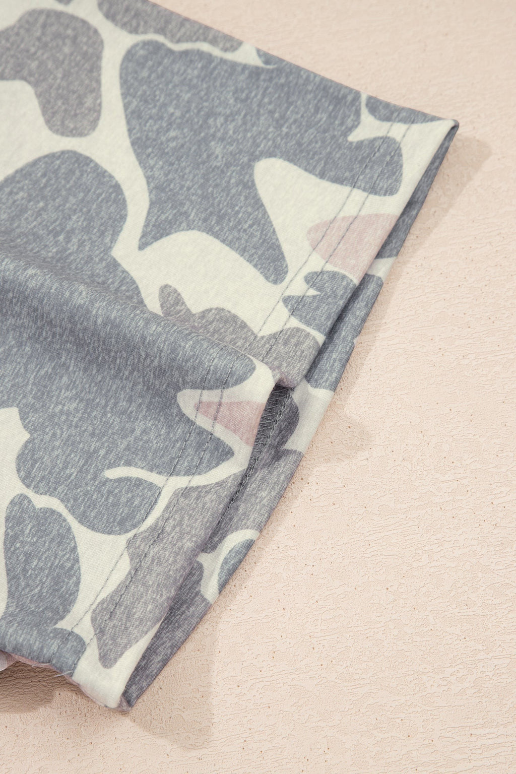Somethinguluv3 casual lounge set featuring a soft, muted grey and white camouflage print fabric detail.