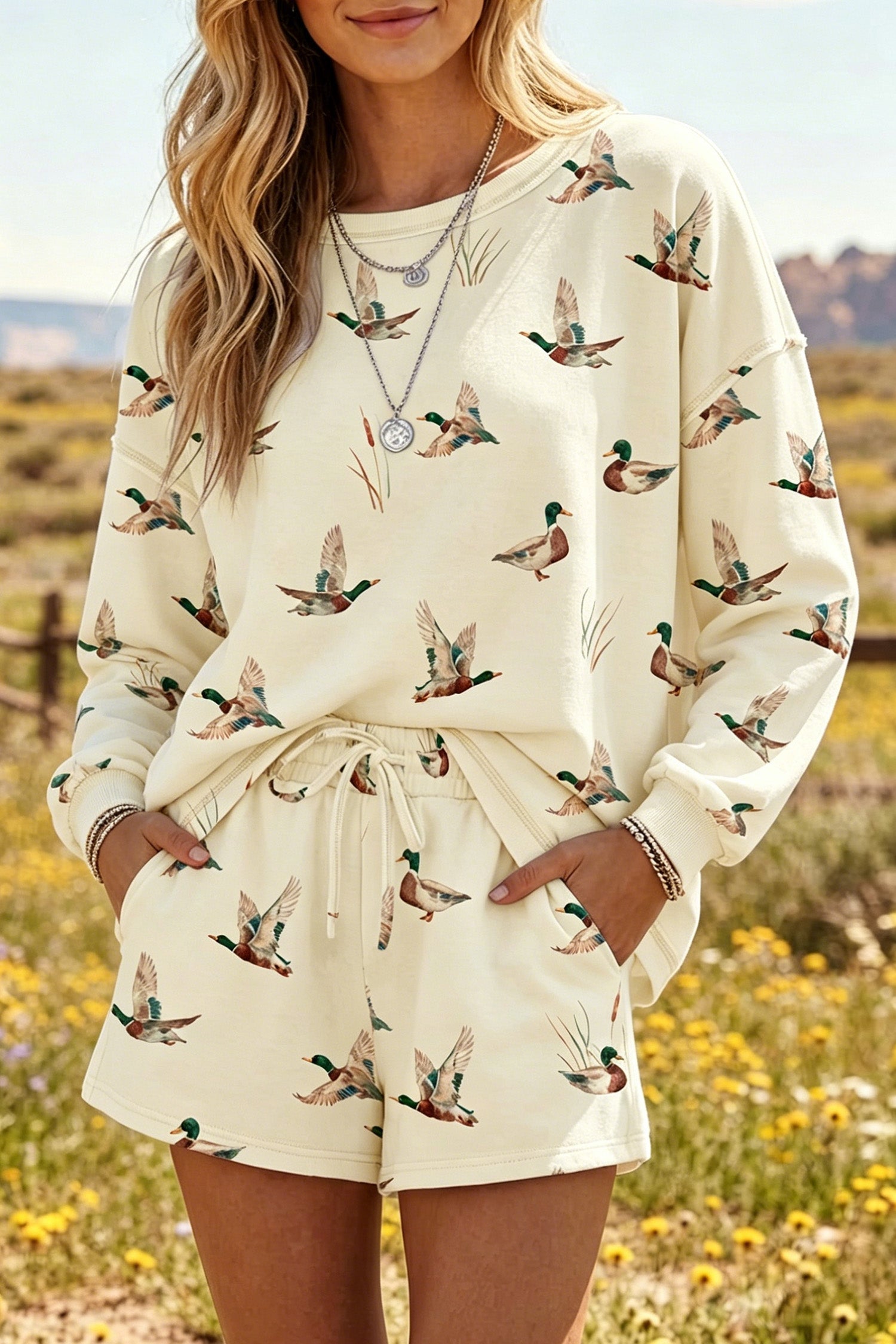Somethinguluv3 cream lounge set featuring a long-sleeve crewneck sweatshirt and shorts with an all-over duck print.