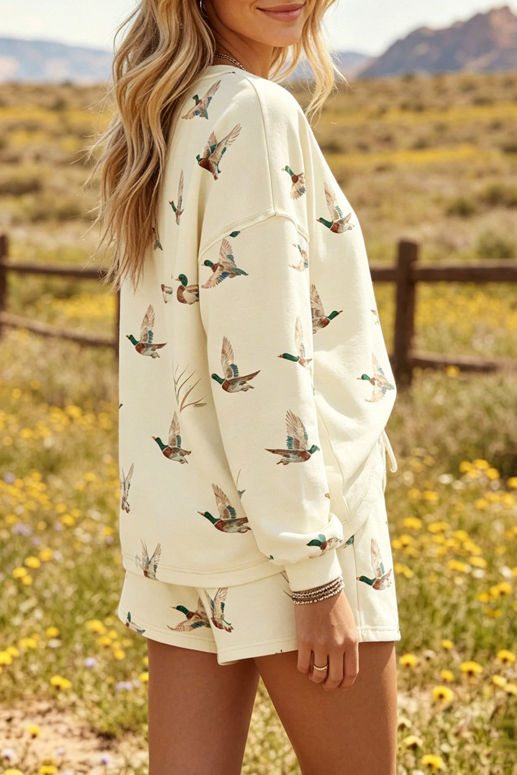 Somethinguluv3 cream lounge set with long-sleeve crewneck sweatshirt and shorts featuring an all-over green duck print.