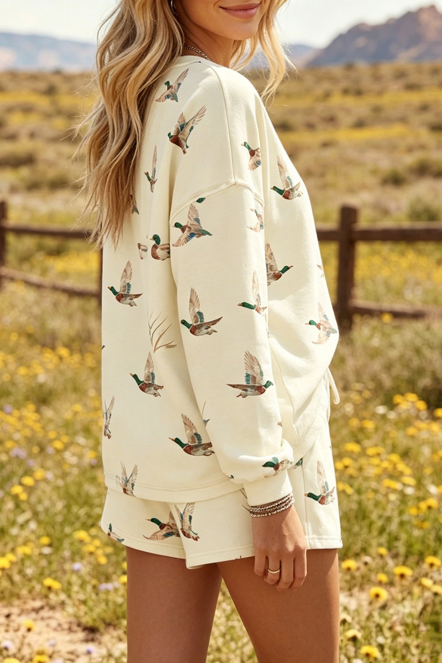 Somethinguluv3 cream lounge set with long-sleeve crewneck sweatshirt and shorts featuring an all-over green duck print.