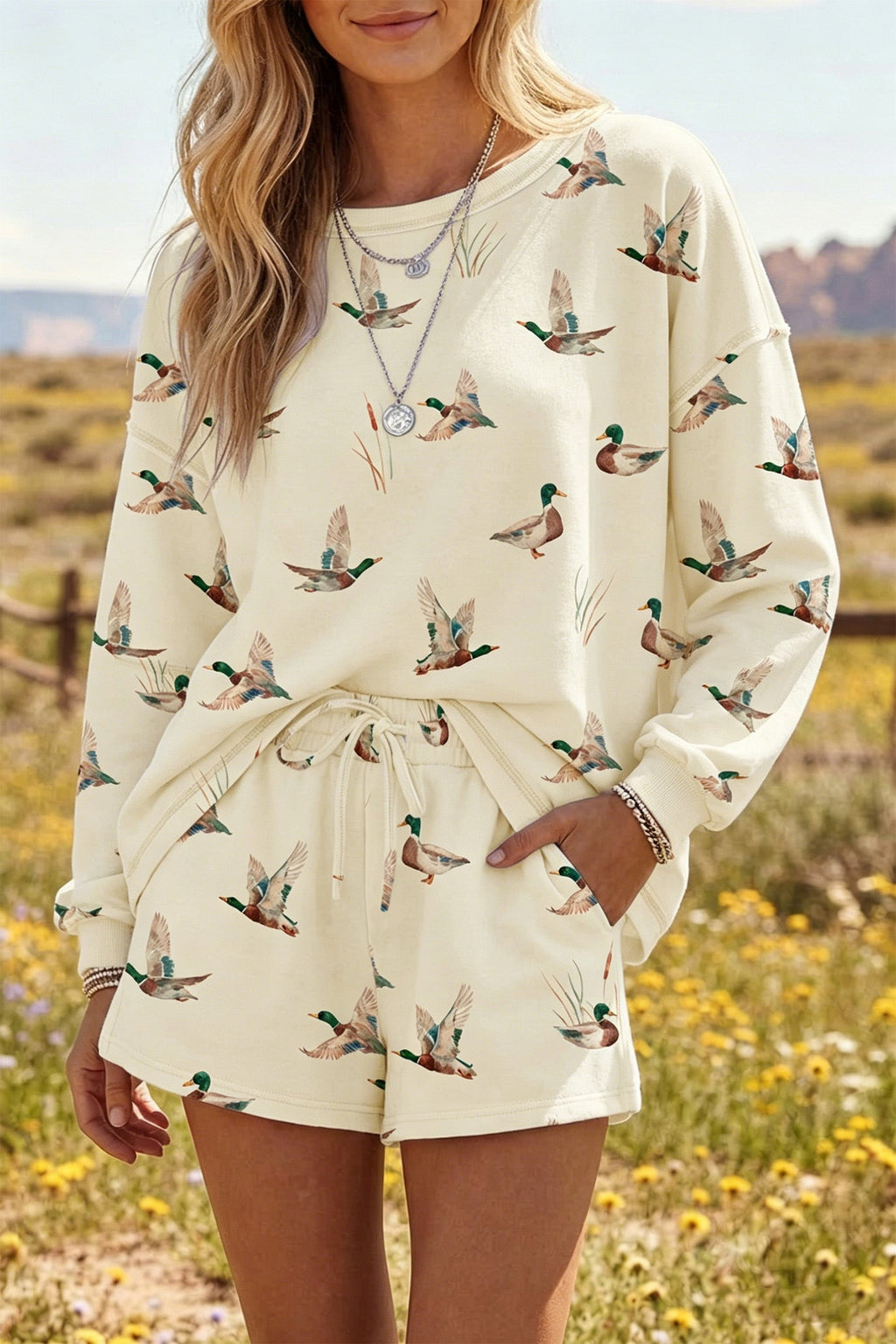 Somethinguluv3 casual lounge set featuring a cream long-sleeve crewneck sweatshirt and shorts with a green duck print.