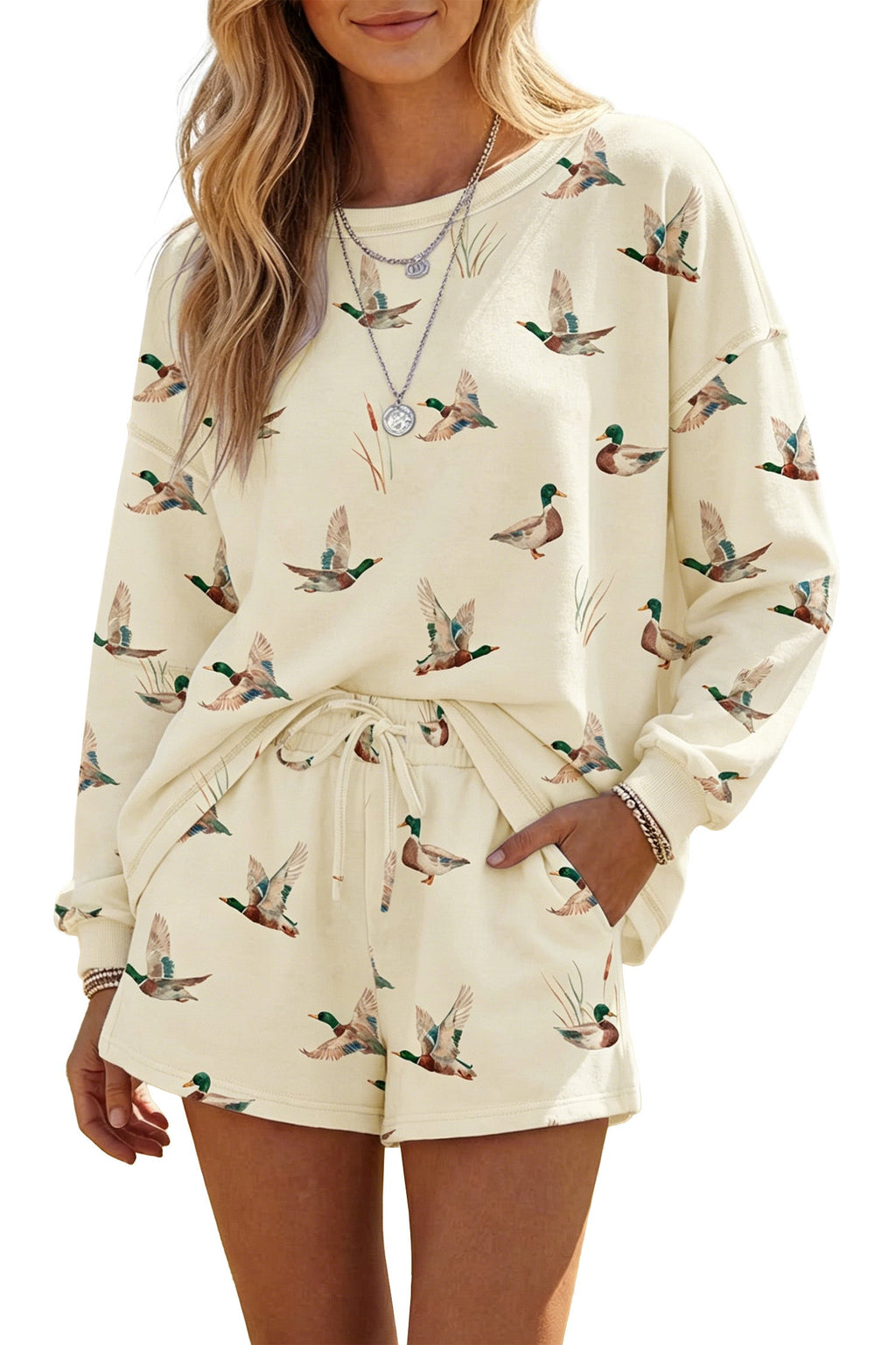 Somethinguluv3 cream lounge set featuring a long-sleeve crewneck sweatshirt and shorts with an all-over duck print.
