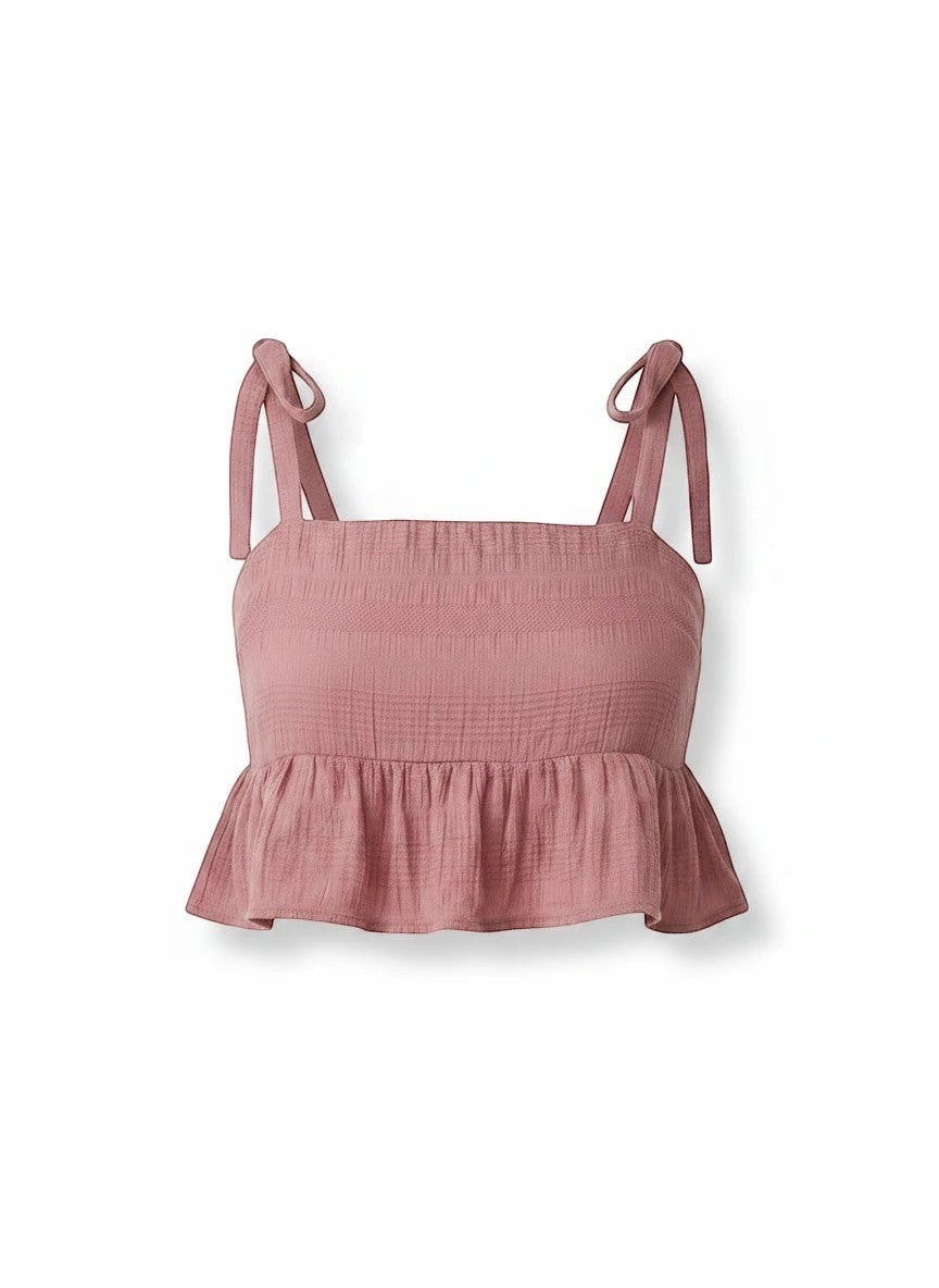 Somethinguluv3 dusty rose textured crop top with square neckline, adjustable tie straps, and a playful ruffle hem.