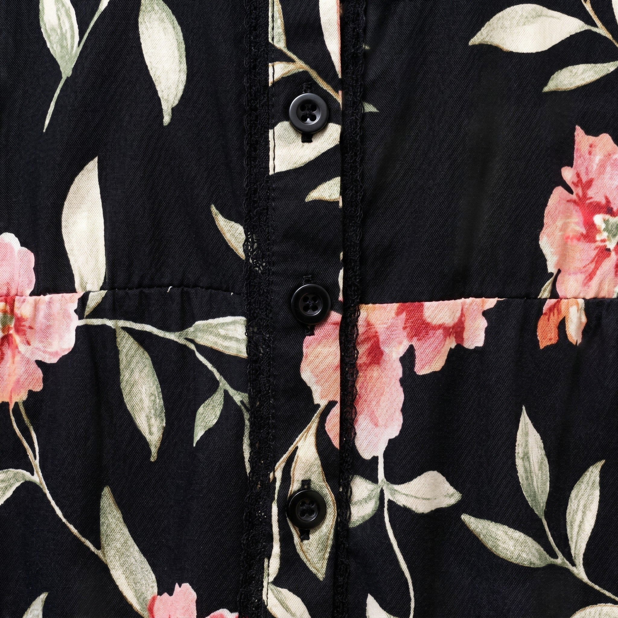 Somethinguluv3 black sleeveless peplum tank top with pink floral print, button-up front, and delicate lace trim.