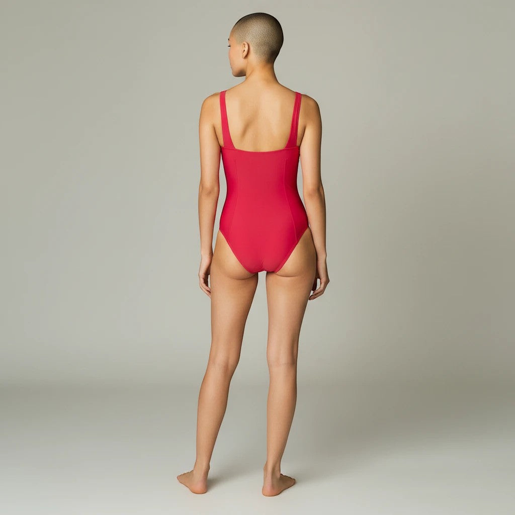 Somethinguluv3 hot pink square neck one-piece swimsuit with high-cut leg worn by a model, back view