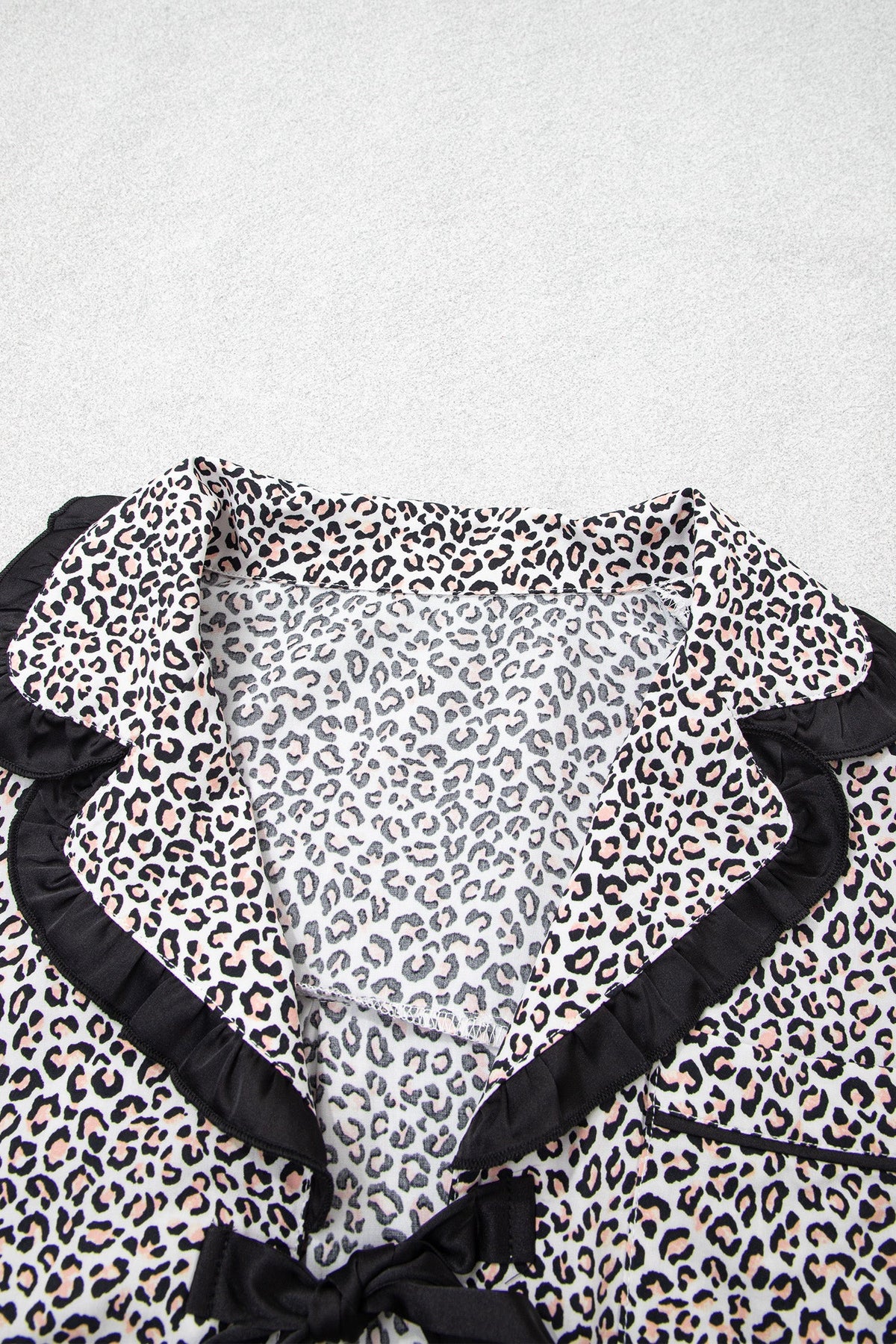 Somethinguluv3 leopard print pajama top with black ruffled trim and a feminine bow knot detail at the collar
