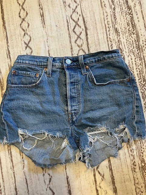 Somethinguluv3 Levis 501 medium wash denim cut-off shorts with a button-fly closure and distressed frayed hem.