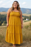 Somethinguluv3 mustard yellow cotton gauze tiered maxi dress with a smocked bodice and ruffled details on a model.