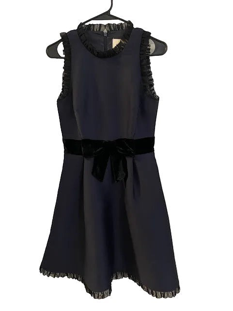 Somethinguluv3 navy blue sleeveless fit and flare dress with velvet bow detail and ruffled neckline. Polyester blend.