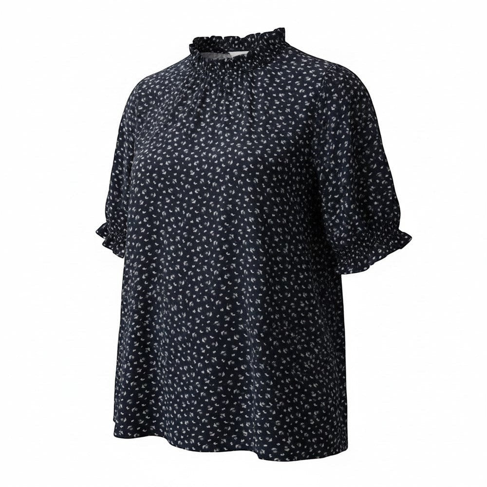 Somethinguluv3 navy blue floral print blouse with a mock ruffle neck and short sleeves with ruffled cuffs.