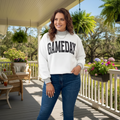 Somethinguluv3 plus size white reversible sweatshirt with GAMEDAY lettering, worn by a woman on a porch.