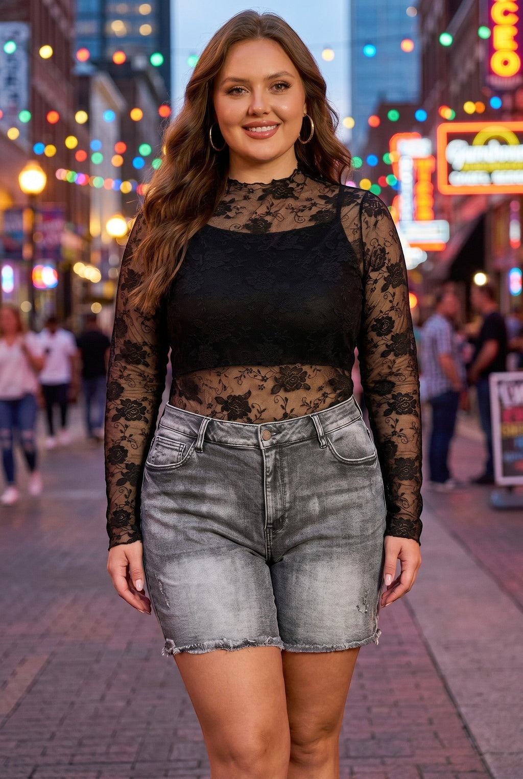 Somethinguluv3 high rise stone washed denim Bermuda shorts with frayed hem worn by a woman in a black lace top