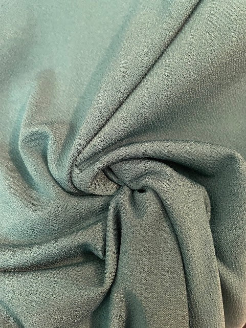 Somethinguluv3 teal blouse fabric with a soft, textured finish and elegant drape.